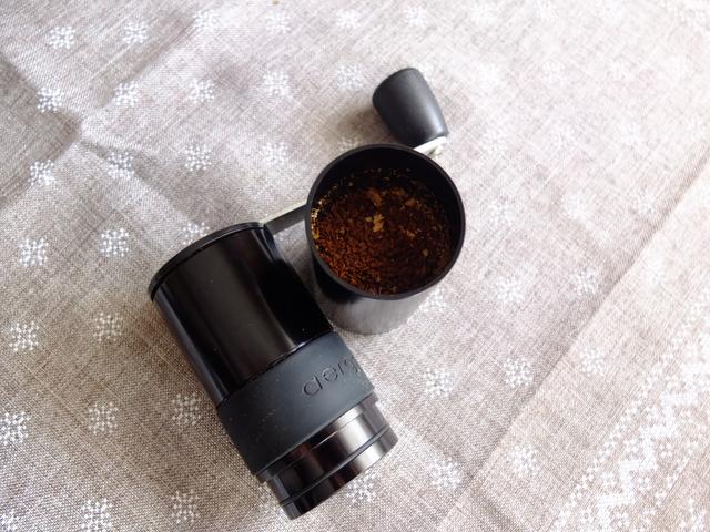 Ground coffee in the bottom jar of the grinder